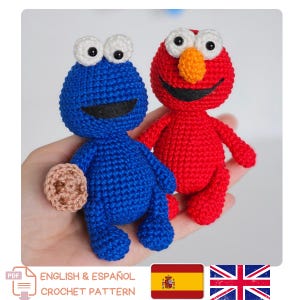 May include: Two handmade crochet dolls: a blue Cookie Monster holding a cookie and a red Elmo. Both dolls have large white eyes with black pupils, and black smiles. The image includes text that says "ENGLISH & ESPAÑOL CROCHET PATTERN".