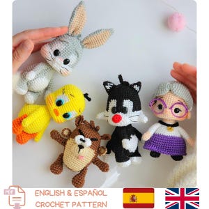 May include: A collection of handmade crochet character dolls, including Bugs Bunny, Tweety Bird, Taz, Sylvester the Cat, and Granny. The dolls are in various colors, with detailed facial features. The image also includes the text "ENGLISH & ESPAÑOL CROCHET PATTERN".