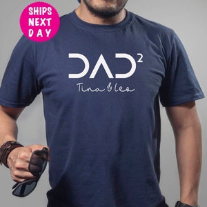 May include: A navy blue t-shirt with white text that reads "DAD² Tina & Leo".