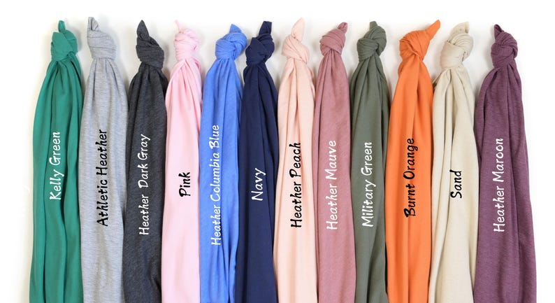 a bunch of different colored ties hanging on a wall