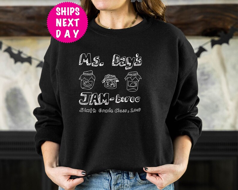May include: Black sweatshirt with white text that reads "Ms. Day's JAM-boree Sixth Grade Class, 2009" and three jars with lids.