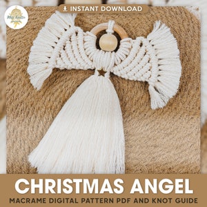 May include: A white macrame Christmas angel ornament with a wooden bead head and a gold star. The angel has a long white tassel and is hanging on a brown background.