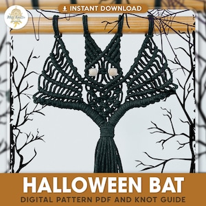 May include: A black macrame bat wall hanging with wooden beads for eyes. The bat is hanging from a wooden dowel rod. The background is a white and black pattern of branches.