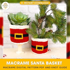 May include: Two macrame Santa baskets, one with a green succulent plant and the other with a small pine branch. The baskets are red and white with a black and yellow belt design. The text "MACRAME SANTA BASKET" is at the bottom of the image. The text "MACRAME DIGITAL PATTERN PDF AND KNOT GUIDE" is below the main text.