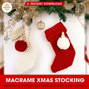 May include: Two macrame Christmas stockings, one red and one white, with wooden beads and pom-poms. The stockings are hanging from a garland of greenery and gold ribbon. Macrame Xmas Stocking. Macrame Digital Pattern PDF and Knot Guide.