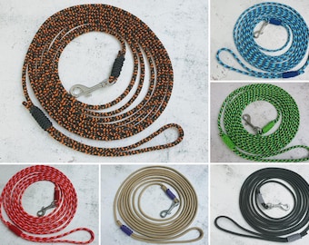 May include: Six different dog leashes in various colors and patterns. The leashes are made of rope and have a metal clip on one end. The leashes are coiled up and laid out on a white surface.