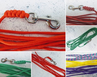May include: Assortment of colorful dog leashes with metal clips. The leashes are made of braided rope and come in red, green, yellow, purple, and pink.