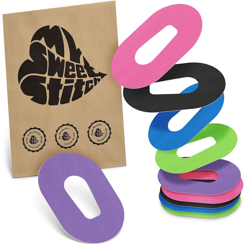 May include: A selection of oval-shaped adhesive patches in various colours: pink, black, blue, green, and purple. A brown paper bag with the text "My Sweet Stitch" in a heart shape is on the left, with three small circular logos.