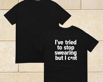 May include: Black t-shirts with a crew neck. One shirt displays the text "I've tried to stop swearing but I c*nt" in white. The other shirt is plain black.