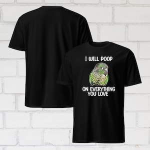 May include: Black t-shirts with a humorous graphic. One shirt's front features a green and yellow parrot with the text "I WILL POOP ON EVERYTHING YOU LOVE." The other shirt is plain black.