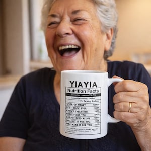May include: A white ceramic mug featuring black text titled YIAYIA Nutrition Facts. The label lists attributes including Giver of Money 1000%, Best Cook Ever 550%, Knows Everything 100%, Force Feeds You 500%, Doesn't Need Recipe 100%, and Will Buy It For You 110%.