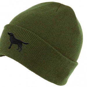 May include: A green knitted beanie with a black embroidered silhouette of a dog on the side.