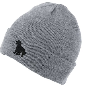 May include: Gray beanie with a black silhouette of a dog embroidered on the front.