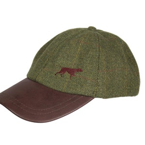 May include: A green tweed baseball cap with a brown leather bill. The cap has a red embroidered dog silhouette on the front.