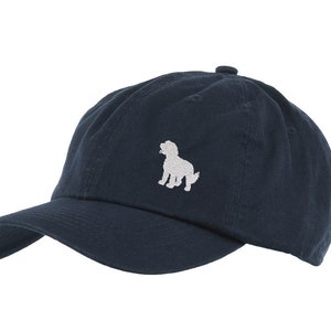 May include: A navy blue baseball cap with a white embroidered dog silhouette.