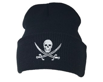 May include: A black knit beanie with a white embroidered skull and crossbones design.