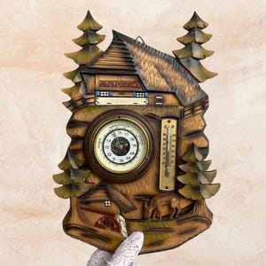 May include: A wooden weather station featuring a carved chalet design with pine trees. It includes a barometer, a thermometer, and a detailed landscape with a deer and a small building. The color palette is primarily brown and green.