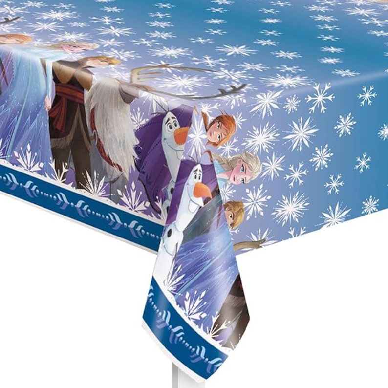 May include: A blue plastic tablecloth featuring characters from the animated movie "Frozen." The tablecloth has a snowflake pattern and images of Elsa, Anna, Olaf, and Kristoff. The border is a dark blue with white accents.