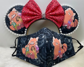 May include: A set of themed accessories featuring a cartoon red panda and characters on a black background with a starry design. Includes a face mask, a headband with a red sequined bow, and matching ears trimmed with white pearls.