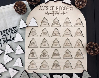 May include: A wooden Acts of Kindness advent calendar with a light wood finish. The calendar features 24 tree-shaped cutouts with acts of kindness written inside. Includes individual tree-shaped numbered pieces and a linen bag.