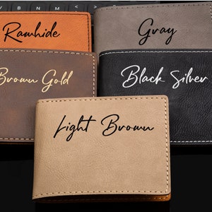 May include: Five leather wallets in different colors, each with a different color of text. The colors are: Rawhide, Gray, Brown Gold, Black Silver, and Light Brown.