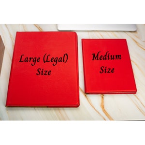 May include: Two red leather binders, one labeled "Large (Legal) Size" and the other labeled "Medium Size".