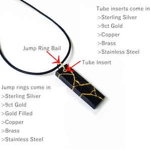 May include: A black and gold pendant with a tube insert. The pendant is attached to a black cord. The pendant can be made with sterling silver, 9ct gold, copper, brass, or stainless steel. The jump ring can also be made with sterling silver, 9ct gold, gold filled, copper, brass, or stainless steel.