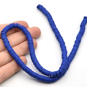May include: A strand of vibrant blue, flat polymer clay beads. The beads are disc-shaped and strung together, creating a flexible, necklace-like form. The beads are a solid, saturated blue color, and are displayed against a white background.