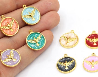 May include: A collection of round pendants with a gold-colored bird design. Each pendant features a different colored background, including red, blue, green, pink, and black, with a gold-colored border. The pendants have a small loop at the top for attaching to a chain or other jewelry.