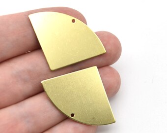 May include: Two brass-colored, quarter-circle shaped metal jewelry components. Each piece has a small hole drilled near the corner. The components have a brushed metal finish and are displayed against a white background.