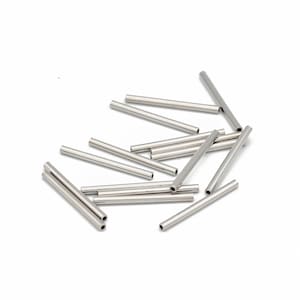 May include: A collection of small, shiny, silver-colored metal tubes scattered on a white surface. The tubes are cylindrical with open ends, suggesting they may be components for jewelry making or other crafts.