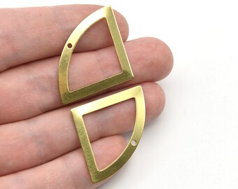 May include: Two brass-colored, geometric earring components. Each piece is a quarter-circle shape with a rectangular frame and a small hole for attachment. The components are held against a white background.