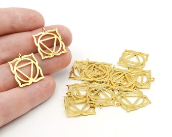 May include: Gold-colored metal pendants with a geometric design, featuring a triangle within a circle, surrounded by a floral-like border. The pendants are small and suitable for jewelry making or crafting. The image shows several pendants.