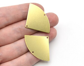 May include: Two brass-colored, quarter-circle shaped metal components with two small holes each. The components have a matte finish and are displayed against a white background. These are likely jewelry making supplies.