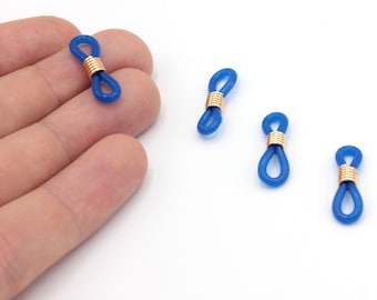 May include: Four blue eyeglass retainers with gold-colored metal coils. The retainers are made of a flexible, rubber-like material and are designed to attach to the arms of eyeglasses to keep them secure.