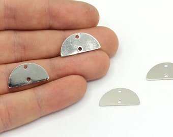 May include: Silver-toned, half-circle metal charms with two holes for jewelry making. The charms have a brushed finish and are displayed on a white background. These findings are suitable for earrings, pendants, or other craft projects.