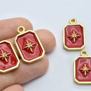 May include: Red and gold rectangular charms with a starburst design and a small crystal in the center. The charms have a gold border and a loop at the top for attaching to jewelry. These charms are ideal for creating necklaces, bracelets, and earrings.