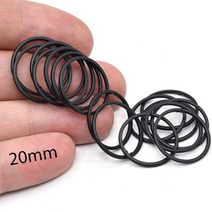 May include: A collection of black rubber O-rings, each approximately 0.79 inches in diameter, are displayed against a white background. The text "20mm" is visible, indicating the size of the rings. These rings are likely used for sealing purposes.