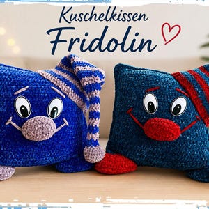 Könnte beinhalten: Zwei quadratische Plüschkissen mit Cartoon-Gesichtern, die jeweils eine gestreifte Schlafmütze tragen. Das linke Kissen ist blau mit einer hellvioletten Nase und Mütze. Das rechte Kissen ist dunkelblau mit einer roten Nase und Mütze.