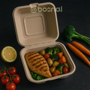 May include: A beige, open takeout container filled with grilled chicken breast, broccoli, tomatoes, potatoes, and carrots. A lemon half and a cluster of tomatoes are on the left. The background is black.