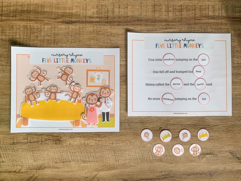 May include: A nursery rhyme activity set titled Five Little Monkeys featuring a printed scene with a yellow bed, five monkey cutouts, a doctor, and a parent monkey. Includes a text sheet with fill-in-the-blank circles and seven small circular tokens.