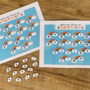 May include: Two white rectangular sheets with the text "uppercase & lowercase ALPHABET MATCHING" featuring rainbow and cloud illustrations with letters A through Z. A collection of small, individual white cloud-shaped pieces with lowercase letters.