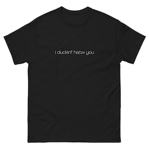May include: Black t-shirt with the text "i duckinf hatw you" printed in white.