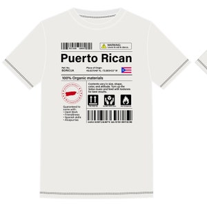 May include: White t-shirt with a black and white label that says "Puerto Rican" with a red stamp that says "Authentic Product of Puerto Rico". The label also includes the text "100% Organic Materials" and a list of guaranteed qualities, including "Hard Work", "Friendliness", "Spanish Skills", and "Alcapurrias".