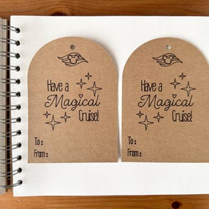 May include: Two brown paper gift tags with a rounded top and a hole for string. Each tag has the text "Have a Magical Cruise!" and a ship graphic. Below the text are the words "To:" and "From:"