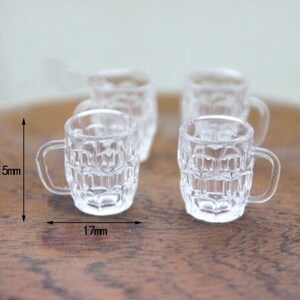 May include: Four clear glass mugs with a textured design. The mugs are 1.5 inches tall and 1.7 inches wide.
