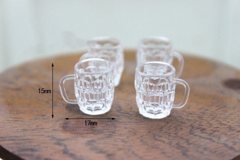 May include: Four clear glass mugs with a textured design. The mugs are 1.5 inches tall and 1.7 inches wide.