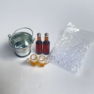 May include: A miniature set for a dollhouse or miniature scene, featuring a silver metal bucket, two brown glass bottles, two clear glass beer mugs, and a bag of clear plastic ice cubes.