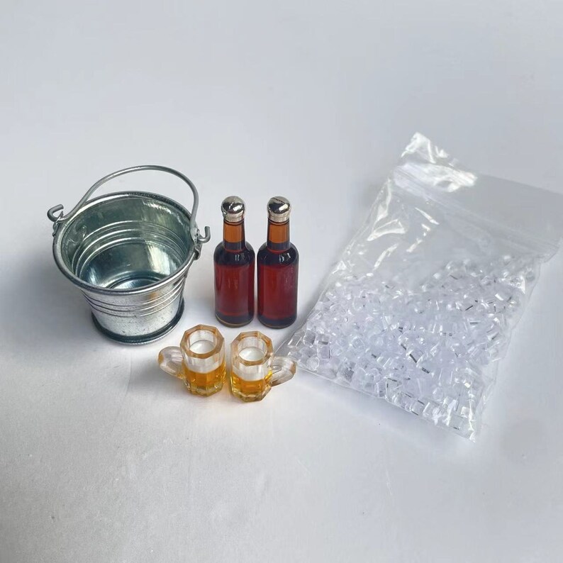 May include: A miniature set for a dollhouse or miniature scene, featuring a silver metal bucket, two brown glass bottles, two clear glass beer mugs, and a bag of clear plastic ice cubes.