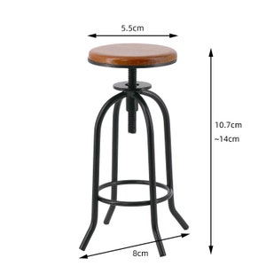 May include: Black metal adjustable bar stool with a brown wood seat. The stool is 10.7cm tall and can be adjusted to a height of 14cm. The seat is 5.5cm in diameter and the base is 8cm wide.
